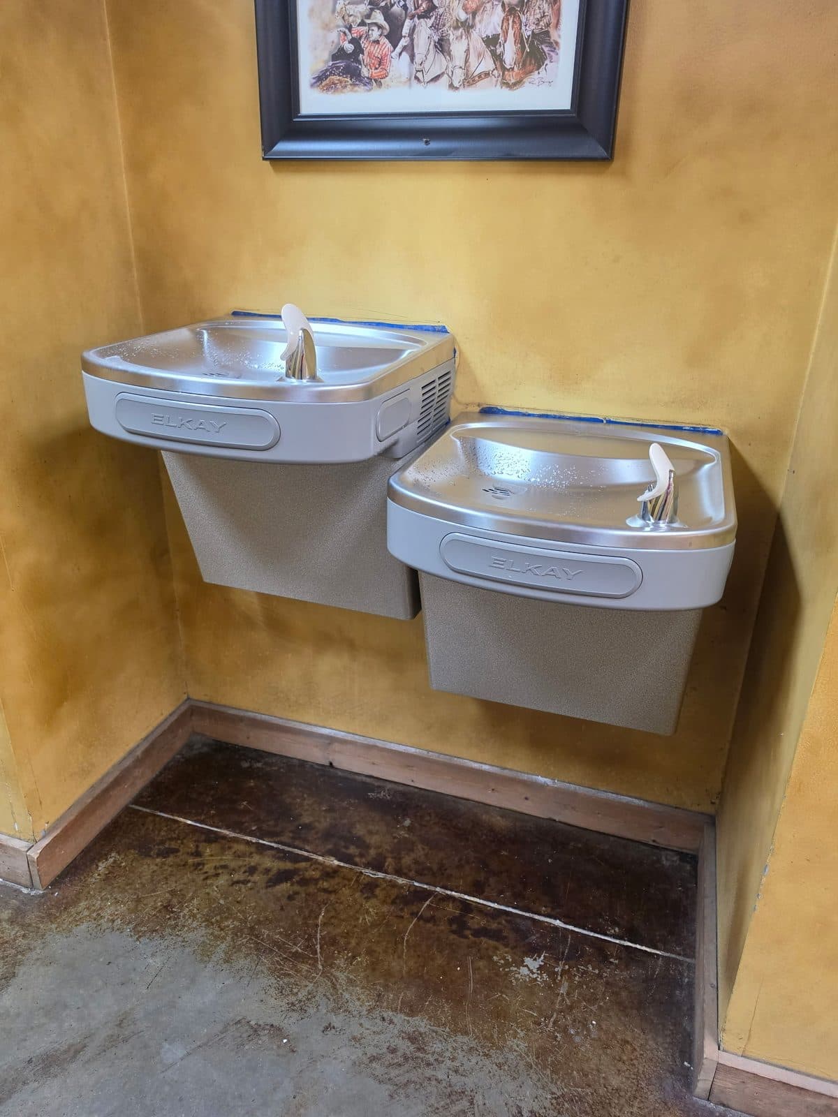 Two Elkay wall-mounted drinking fountains installed at different heights