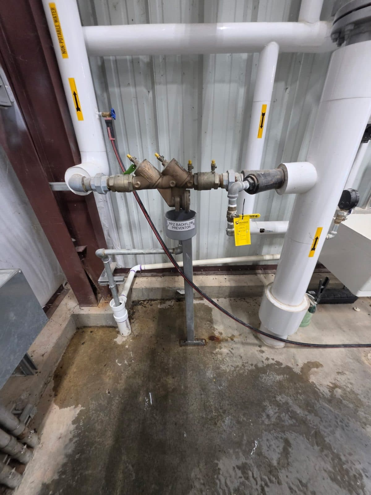 RPZ backflow preventer with non-potable water piping in an industrial facility