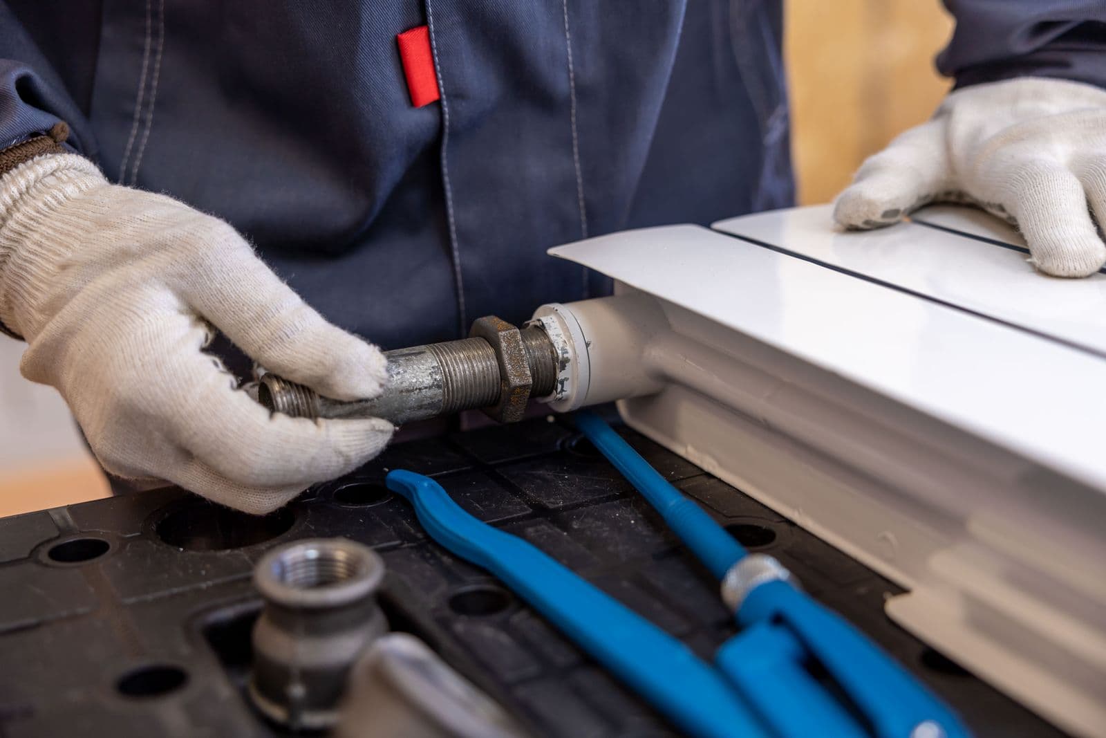 Licensed plumber connecting supply lines on a plumbing job