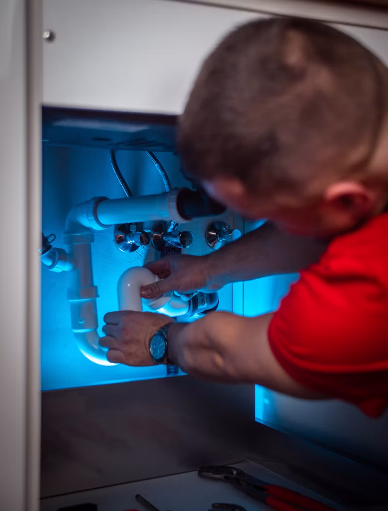 Plumber repairing fixtures and water lines